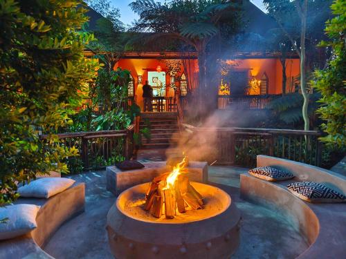 a fire pit in the middle of a yard at Dar Amane Guest House in Graskop