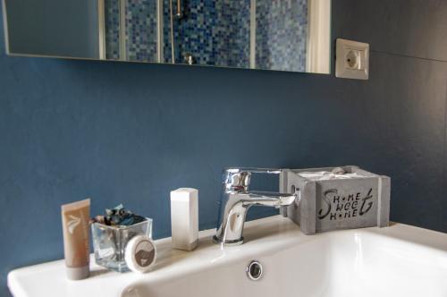 a bathroom sink with a faucet and a mirror at La Rosa Blu in Gerace