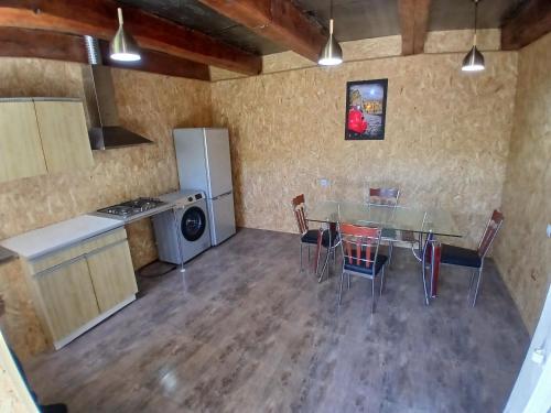 a kitchen and dining room with a table and chairs at Rabat Funicular in Akhaltsikhe