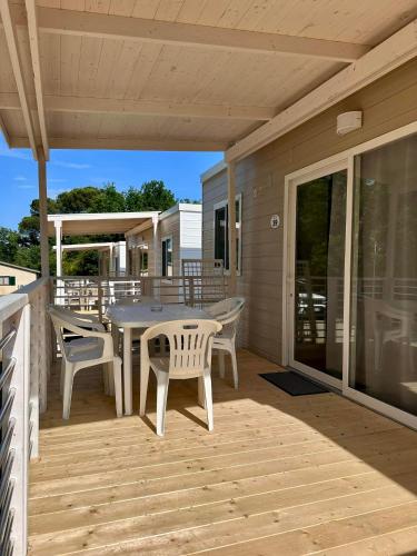 a patio with a table and chairs on a deck at Camping Village Mugello Verde in San Piero a Sieve