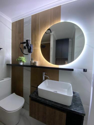 a bathroom with a white sink and a mirror at Apartmani Lazarevic Jagodina in Jagodina