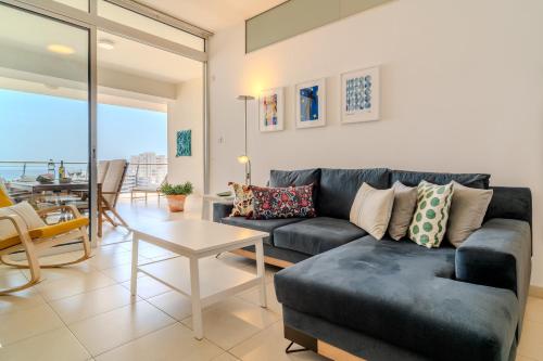 a living room with a couch and a table at Amazing Sea and Marina View City Center 2BDR Flat in Larnaka