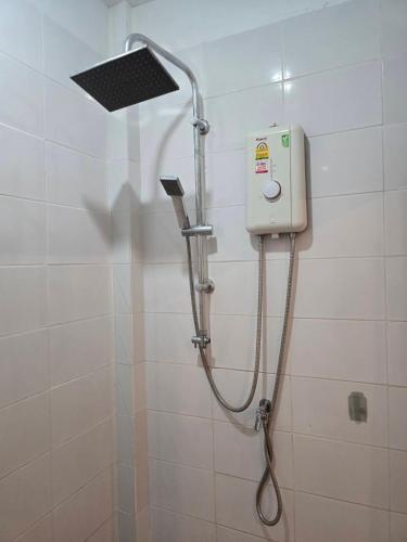a shower in a bathroom with a shower head at แอทชฎา เชียงใหม่ @Shada Chiang Mai in Chom Thong