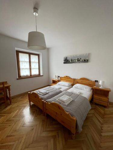 a bedroom with a large wooden bed and a window at Casa Valentina in Ledro