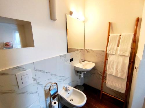 a bathroom with a sink and a mirror at Albergo Del Sole in Porto Valtravaglia