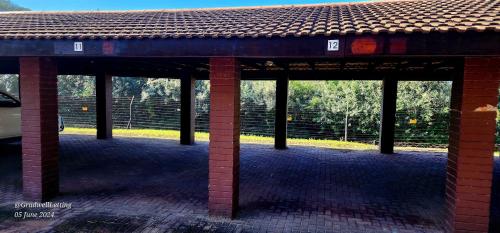 a brick pavilion with columns and a roof at Milkwood Lodge 11 - Sleeps 4 in Port Edward