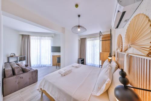 a bedroom with a large bed and a couch at Kas Athena Hotel in Kas