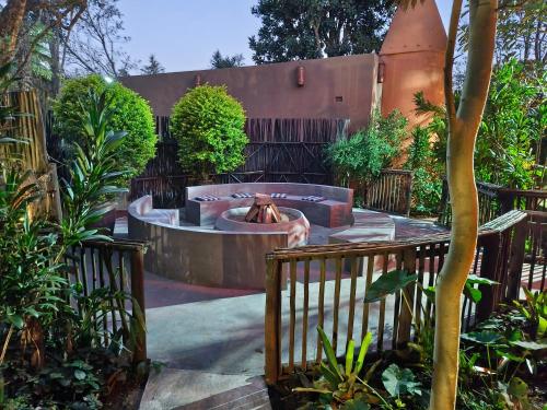 a fountain in the middle of a garden at Dar Amane Guest House in Graskop