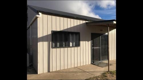 a building with a window on the side of it at Moonbah Loft in Moonbah