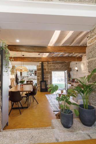 a dining room with a table and some plants at Casa da Bisa Rita in Aldeia Formosa