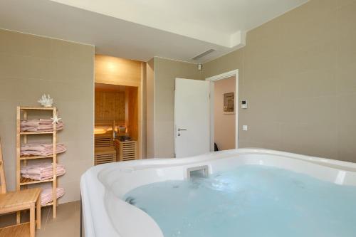 a large bath tub in a bathroom with at Beautiful Villa Village with tennis court in Tinj in Tinjan
