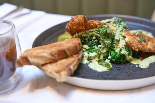 a plate of food with broccoli and fried chicken and bread at The Store in Oxford