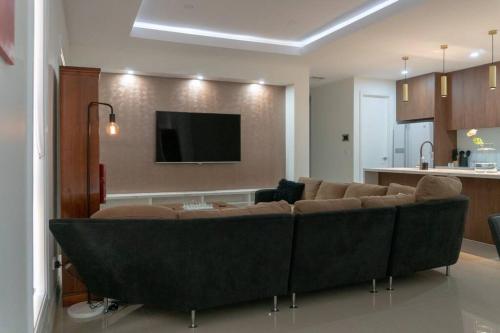 a living room with a couch and a flat screen tv at Hodgson in Tarneit
