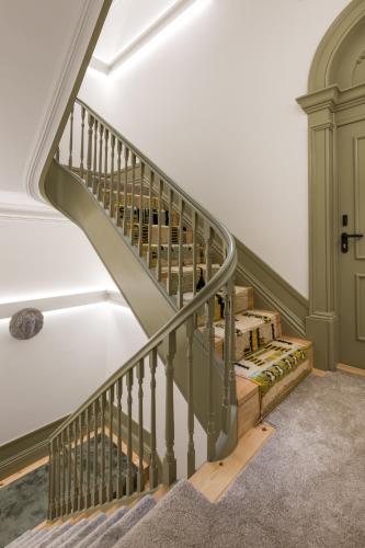 a staircase in a house with a person walking down it at Beco do Paço by Porto Dream Stays in Porto