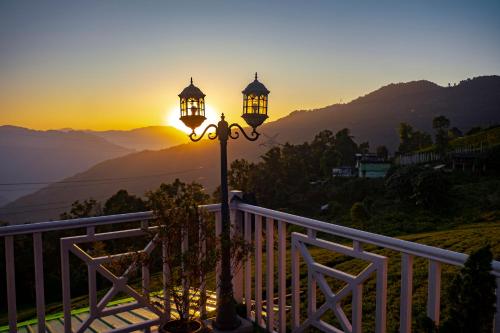 a street light with the sunset in the background at The Temi Bungalow South Sikkim in Namchi