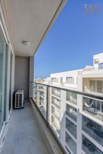 an apartment balcony with a view of the city at The St Pauls Bay Escape Suites by 360 Estates in St Paul's Bay
