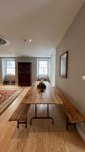 a living room with a wooden table in a room at Matriz 55, Hostel & Suites in Ponta Delgada