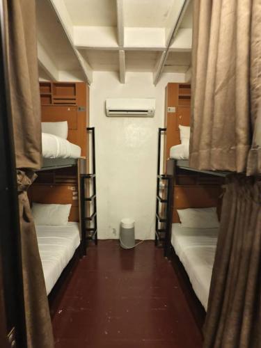a room with three bunk beds in a room at Red Inn Court in George Town