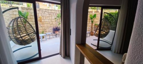 a room with a window with a view of a patio at Hotel Begonvil in Kas