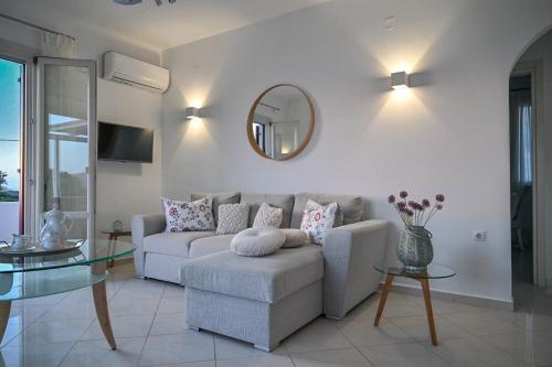 a living room with a couch and a mirror at ‘Sophie’s Villa’ in Naxos Chora