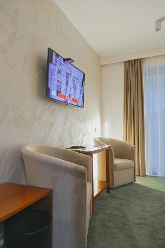 a hotel room with a flat screen tv on the wall at Orlovo gnezdo in Ljubovija