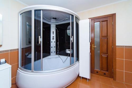 a large shower in a room with a door at Sovinyon Resort in Odesa