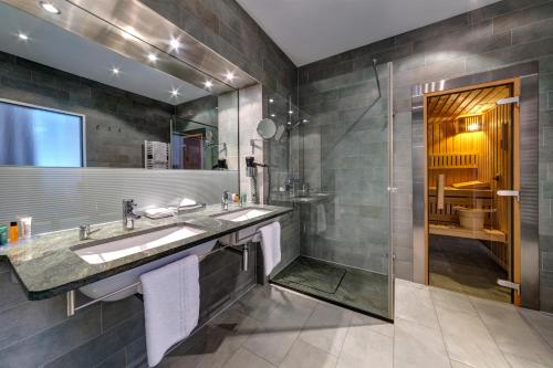 a bathroom with a sink and a shower at Hilton Garden Inn Stuttgart NeckarPark in Stuttgart