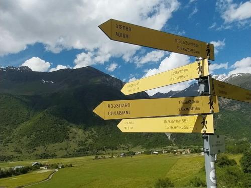 a street sign with arrows pointing in different directions at Guesthouse Leno in Tsaldashi