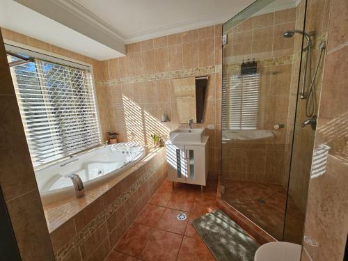 a large bathroom with a tub and a shower at Paradise in Whiteside