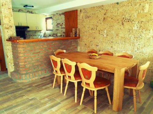 a wooden table and chairs in a room at Vila Vitezov Mir - Drina in Vrhpolje