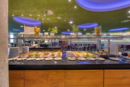 a buffet line with many different types of food at Hilton Garden Inn Stuttgart NeckarPark in Stuttgart