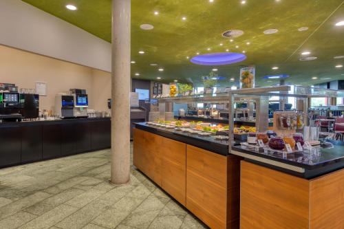 a food counter in a store with food on display at Hilton Garden Inn Stuttgart NeckarPark in Stuttgart