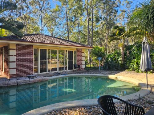 a swimming pool in the backyard of a house at Paradise in Whiteside