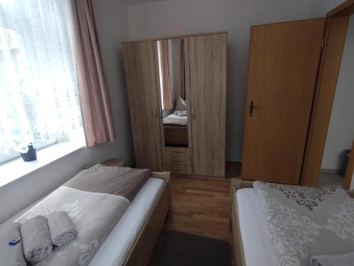 a small bedroom with two beds and a window at Ferienwohnung Lange in Burgstaedt