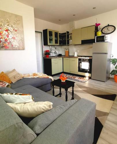 a living room with a couch and a kitchen at Apartment Beba in Kaštela