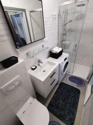 a bathroom with a toilet and a sink and a shower at Apartment Beba in Kaštela