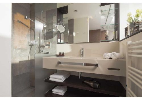 a bathroom with a sink and a shower at MeerBlickD21 in Norderney