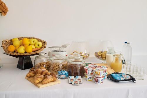 a table filled with food and a basket of fruit at Villa Vittoria Hotel in Alcamo