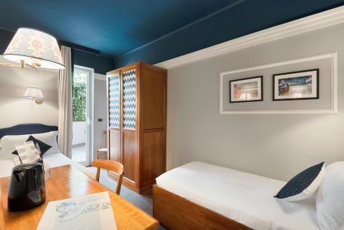 Postel nebo postele na pokoji v ubytování Hotel Vis à Vis