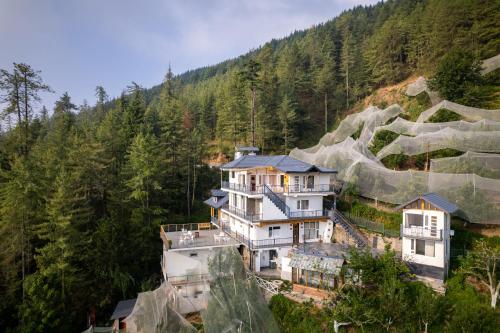 an aerial view of a house on a mountain at Jomotel Dayaar - An Apple Orchard Villa in Theog