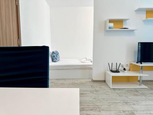 a living room with a couch and a television at Chateau Aheloy 2 - Menada Apartments in Aheloy
