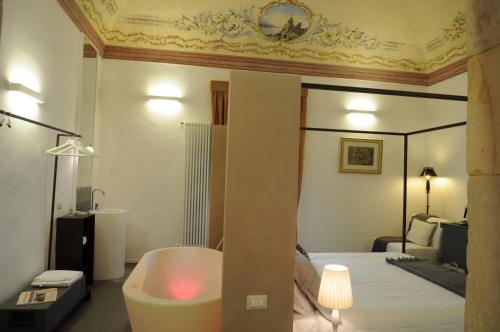 a bedroom with a bed with a bath tub and a bed at Iblainsuite in Ragusa