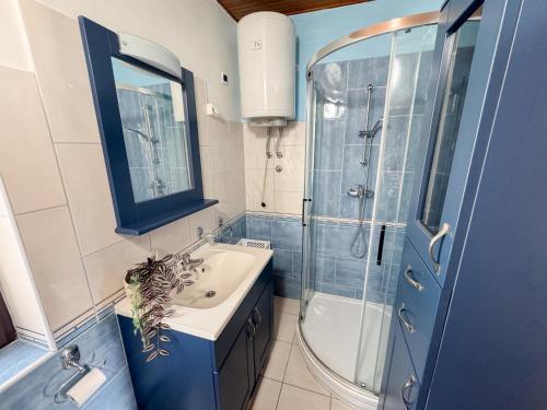a bathroom with a sink and a shower at House Private beach in Bibinje