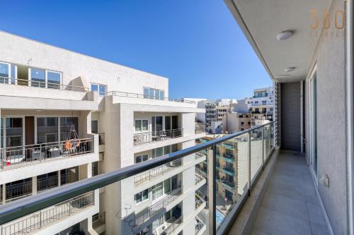 an apartment balcony with a view of the city at The St Pauls Bay Escape Suites by 360 Estates in St Paul's Bay