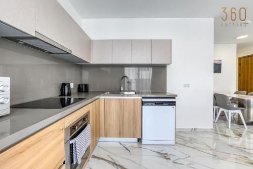 a kitchen with a sink and a dishwasher at The St Pauls Bay Escape Suites by 360 Estates in St Paul's Bay