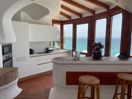 kuchnia z wyspą z widokiem na ocean w obiekcie Chalet El Encanto w mieście Zahara de los Atunes