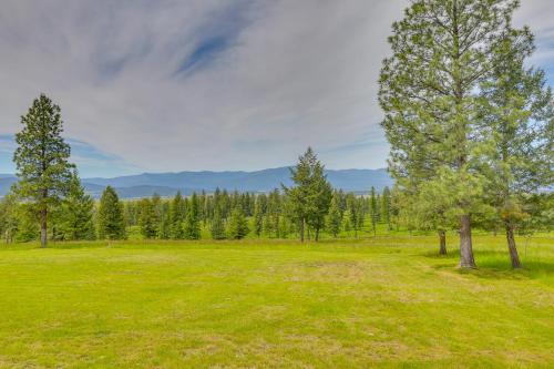 a grassy field with trees and mountains in the background at Hot Tub and Views Sunset Valley Retreat in Eureka in Eureka