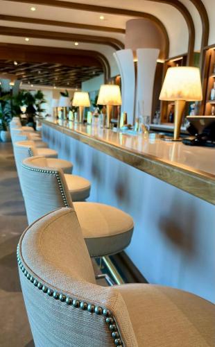 a row of chairs lined up at a bar at Wave Resort in Long Branch