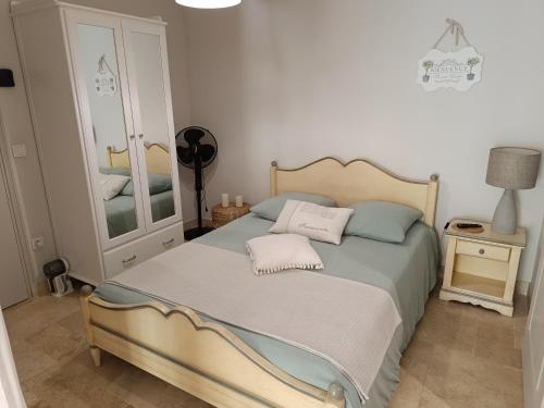 a bedroom with a bed with two pillows on it at La Petite perle, balnéo en supplément, le Clos des Perles in Tourtour