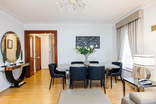 a dining room with a table and chairs at CARLTON COURT - MAYFAIR in London